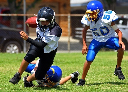 Pee Wee Football Player Breaking Tackle