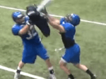 Youth football player shedding block using football practice pad