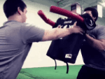Football blocking dummies provide offensive linemen with a realistic mobile target for O line drills Offensive lineman practicing hand placement on football blocking pad