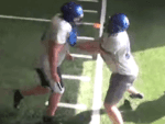 Offensive lineman use revolutionary football training gloves to practice lateral footwork O lineman using The Muzzle training gloves to practice lateral footwork